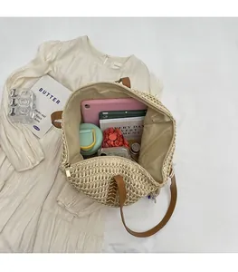 Spacious interior of straw tote bag showing tablet, umbrella, and daily essentials