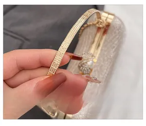 Detail view of champagne glitter evening bag with gold handle and pearl rhinestone clasp