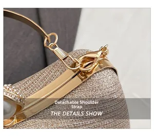Detail of glitter evening bag with gold metal frame, pearl clasp and removable strap