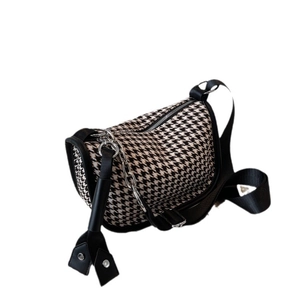 Classic black and white houndstooth crossbody bag with silver chain and leather trim