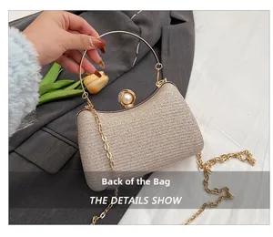 Detail view of champagne gold evening bag featuring a pearl clasp and gold ring handle