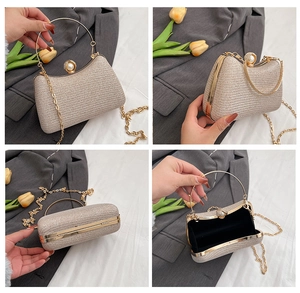 Detail view of gold glitter evening clutch with round metal handle and pearl clasp
