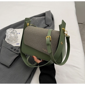 Close-up of olive green leather and brown woven flap on a retro crossbody square bag