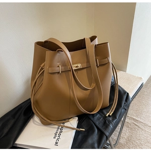 Vintage dark brown leather tote bag with gold clasp and straps for casual daily use