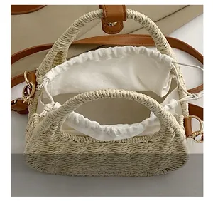 Detail of straw bag featuring white fabric drawstring liner and premium brown leather straps