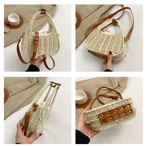 Detail view of woven straw bag with leather handles and protective rivet bottom