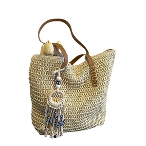 Fashion woven straw tote bag with brown leather straps and evil eye tassel charm