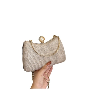 Sparkly gold glitter evening clutch with elegant pearl clasp and chain shoulder strap
