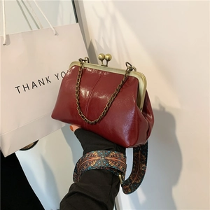 Vintage burgundy glossy frame bag with chic ethnic strap and metal chain detail