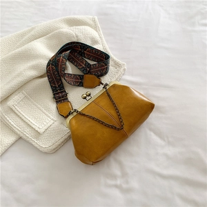 Mustard yellow vintage kiss-lock crossbody bag with a bohemian ethnic wide shoulder strap