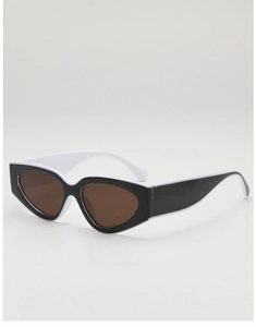Vue détaillée de lunettes de soleil œil-de-chat rétro avec monture noire et branches blanches
