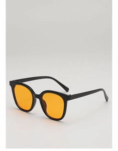 Detail of vintage square black sunglasses frame with vibrant orange sea lenses