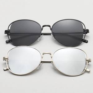 Close-up of retro metal frame sunglasses with black and silver mirrored lenses