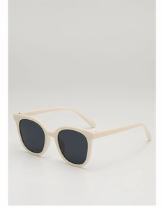 Detail of cream white square sunglasses with dark lenses on a neutral background