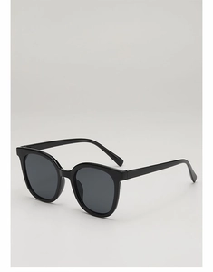Detail view of square black sunglasses with dark gray lenses and premium resin frame