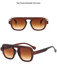 Détail de lunettes pilote couleur thé avec monture texturée et verres dégradés