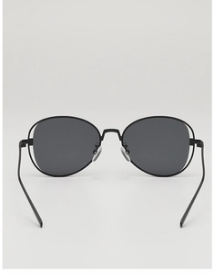 Detail of slim black metal frame sunglasses with oval dark grey lenses and nose pads