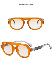 Détail des lunettes aviateur orange avec monture à texture ondulée et verres dégradés