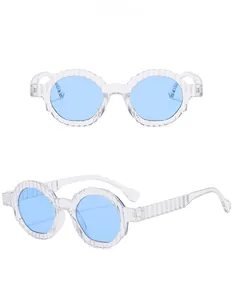 Detail view of transparent retro round sunglasses with blue lenses and textured temples