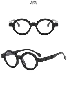 Detail view of black oversized glasses with vertical wavy texture on the frames
