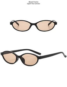 Detail view of oval retro sunglasses with black frames and light tea tinted lenses