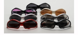 Detailed overhead view of multiple retro futuristic kids sunglasses in various frame colors