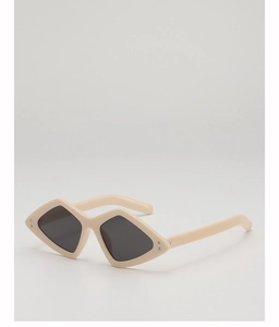 Détail de lunettes de soleil œil-de-chat crème en forme de losange avec rivets argentés