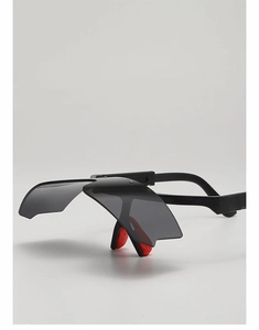 Close-up of kids cycling goggles featuring black polarized lenses and red anti-slip nose pads