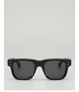 Front view of black square frame sunglasses with silver rivet details and grey lenses