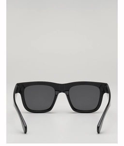 Detail of classic black square sunglasses with dark grey lenses and metal hinges