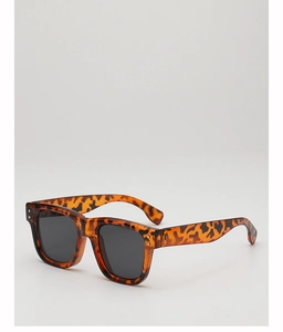 Close-up of retro square tortoiseshell sunglasses with dark lenses and silver dot accents