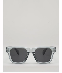 Detail of square tea-grey sunglasses frames with metal rivets and black polarized lenses
