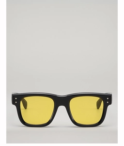 Detailed close-up of retro square sunglasses featuring yellow lenses and star rivets