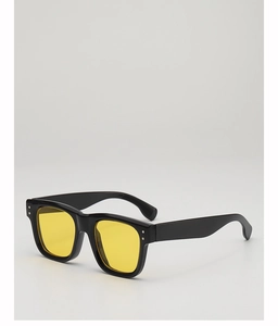Detail of square vintage sunglasses with black frame, yellow lenses and silver rivets