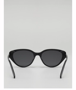Detail view of vintage cat-eye sunglasses with black resin frame and dark lenses