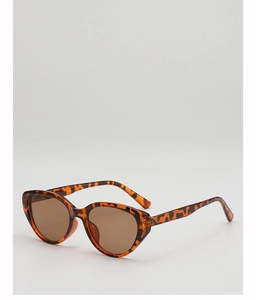 Detail view of tortoiseshell cat-eye sunglasses with premium brown lenses and glossy finish
