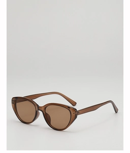 Detail view of retro cat eye sunglasses with transparent brown frames and dark lenses