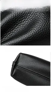 Detailed macro view of black litchi grain leather texture and precise stitching quality