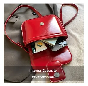Internal view of red oil wax leather handbag showing capacity for phone and lipstick