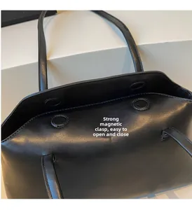 Close-up of high-quality black PU leather handbag featuring a strong magnetic snap closure