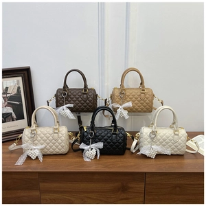 Detailed quilted texture of Boston bags with gold hardware and pearl heart charms
