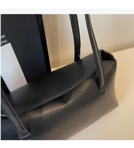 Close-up of premium black PU leather shoulder bag showing detailed stitching and flap texture