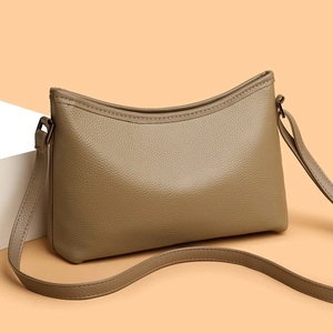 Chic khaki litchi texture shoulder bag with minimalist curved design and metal hardware