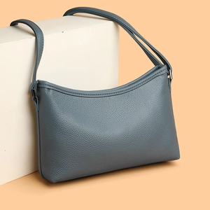 Minimalist blue lychee pattern crossbody bag with textured leather and metal hardware