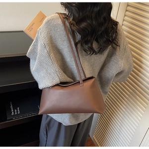 Detail of dark brown minimalist rectangle tote bag made of smooth matte PU leather