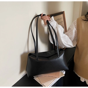 Minimalist black PU leather underarm bag with smooth flap closure for daily office commute