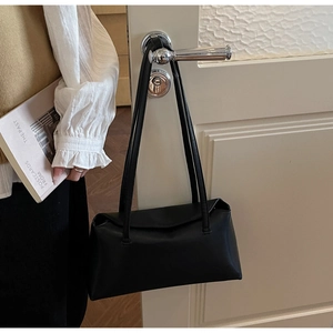 Detailed view of black matte PU leather shoulder bag with double straps and flap closure