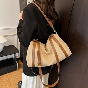 Minimalist beige canvas tote bag with brown leather straps for daily commute use
