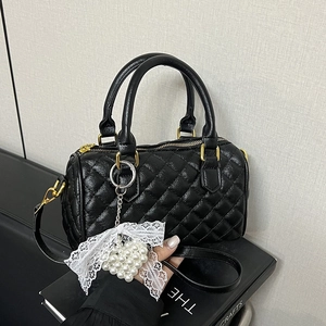 Quilted black Boston handbag with gold hardware and pearl lace bow charm
