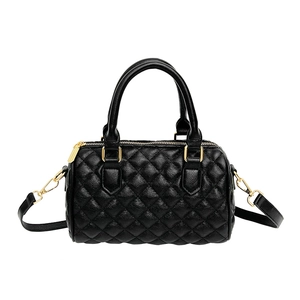 Classic black quilted leather Boston bag with gold hardware and removable strap